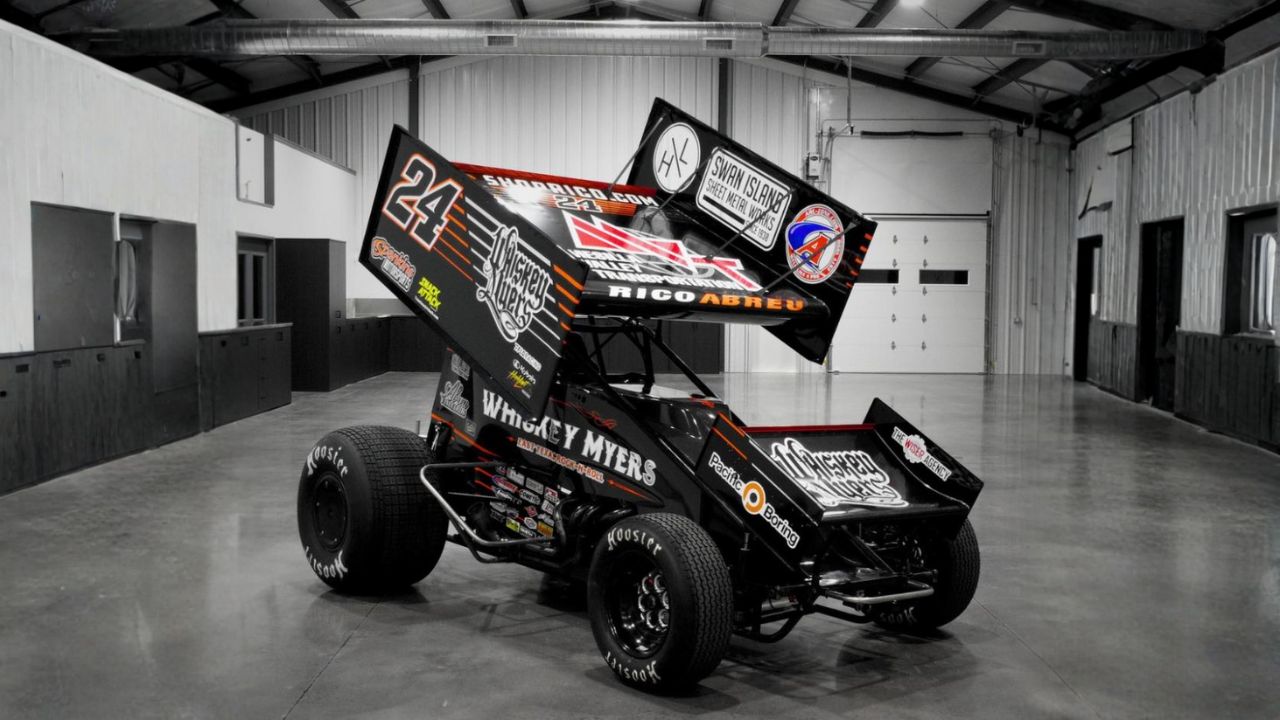 A blue #17 race-ready sprint car, equipped with a complete Five Star sprint car body kit and panels, sliding through a turn on a dirt track.