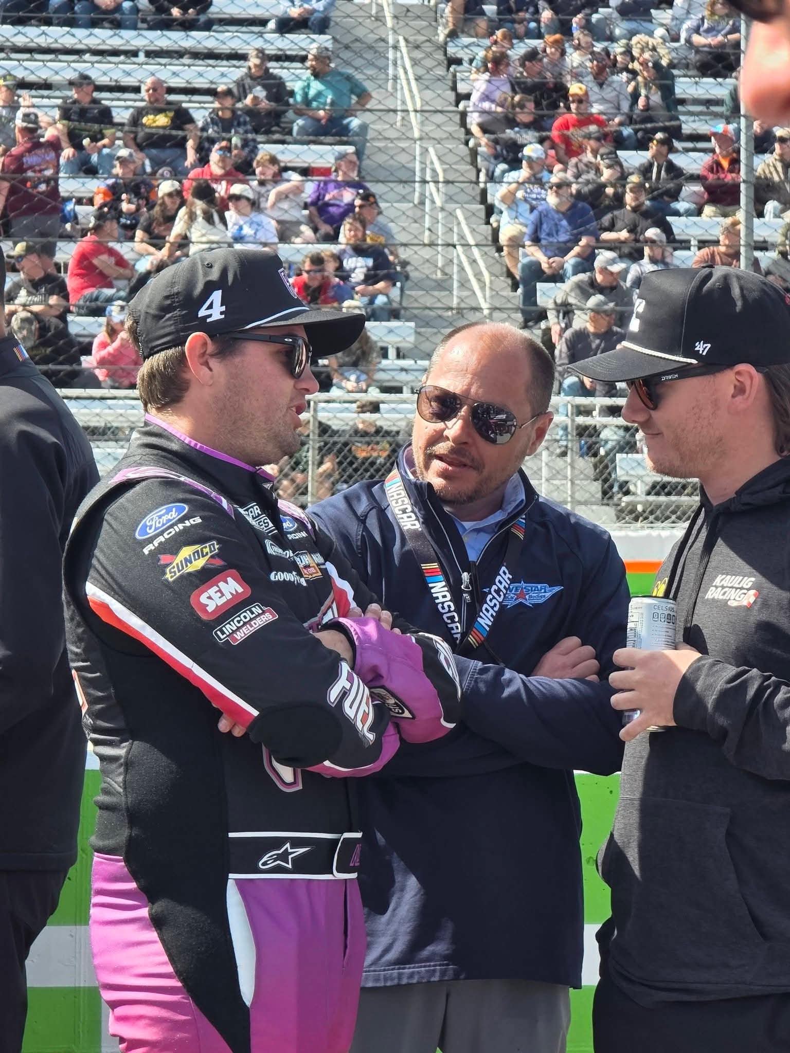 Chris Wiess speaking with racers at a short track racing event