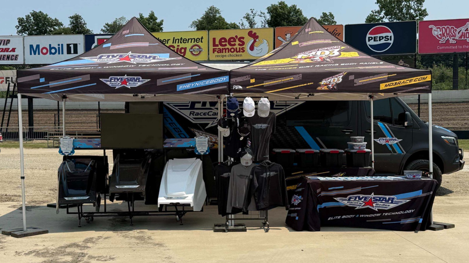 Fans and racers visiting the Five Star display at Eldora Speedway
